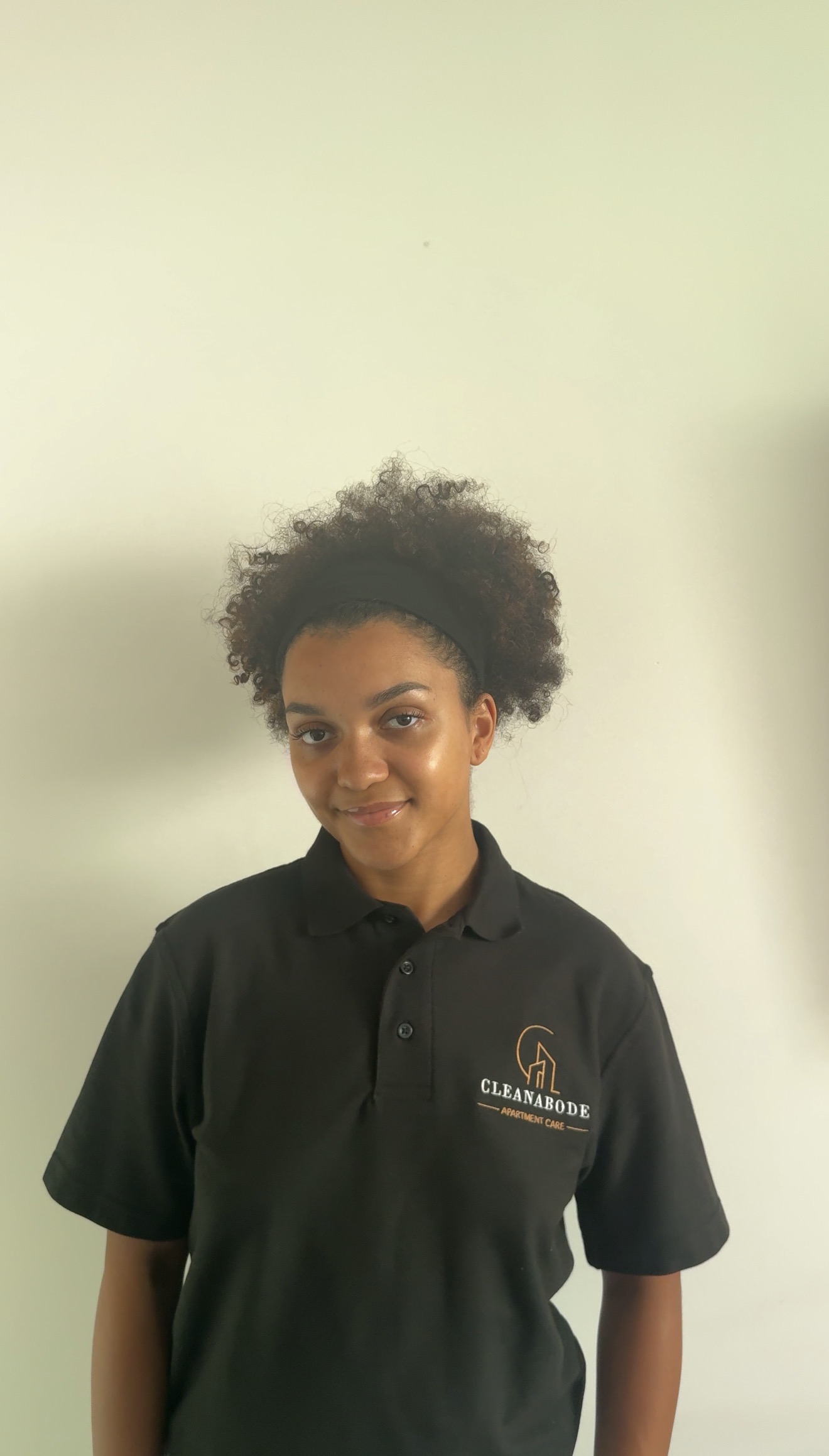 Jen, who personally delivers CleanAbode apartment care, wearing the CleanAbode uniform.